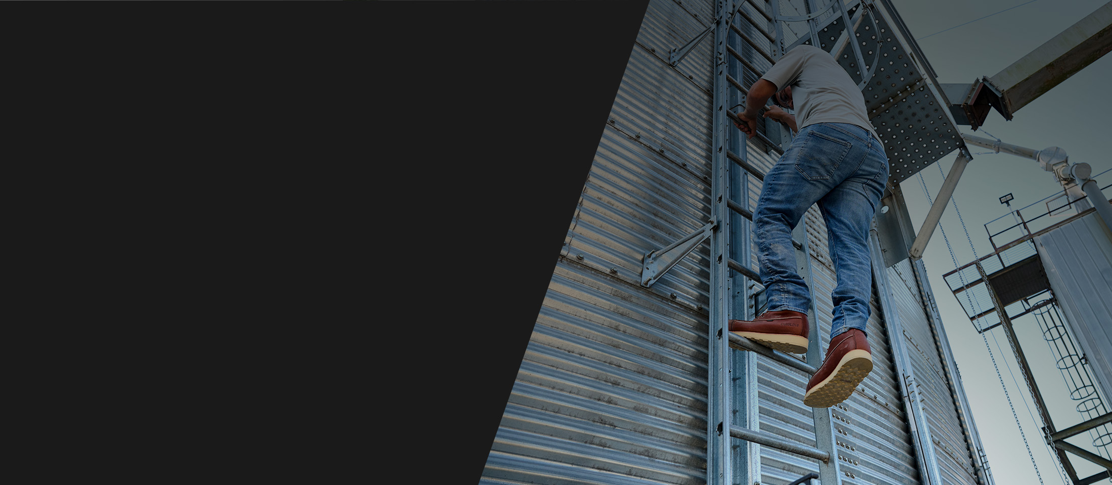A man on a ladder wearing the Staple Gun 8" Carbon Comp Toe Waterproof Work Boot in brown.